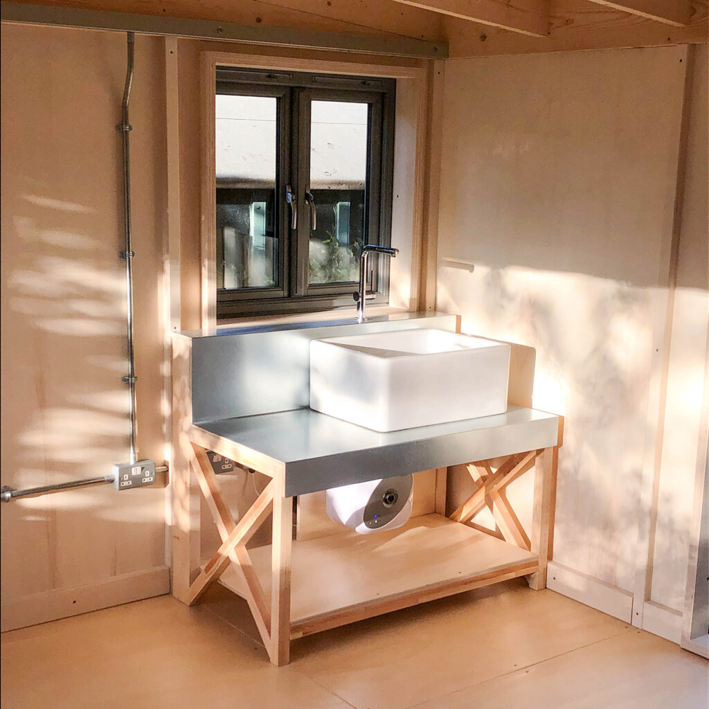 Custom sink designed for pottery in a North Somerset family garden room cabin